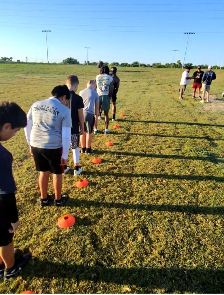 Young athletes running cone drills