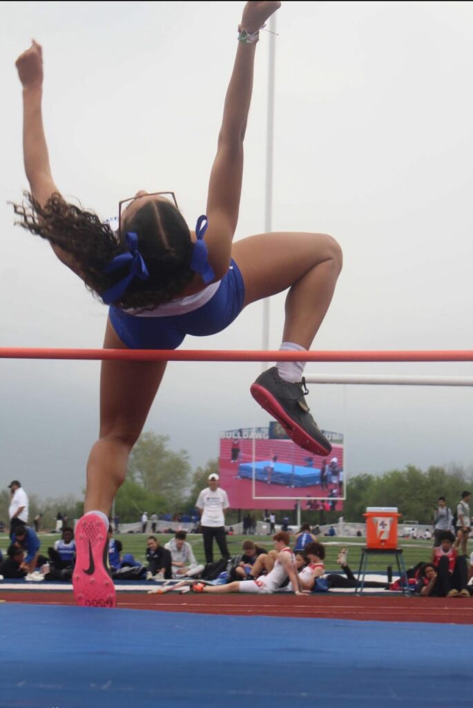 Track athlete clearing the high jump bar